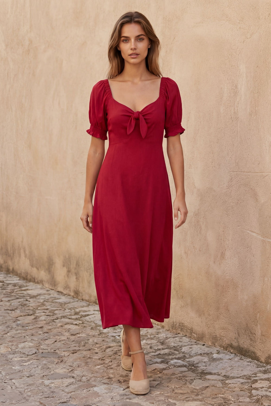 A green fit and flare midi dress with short sleeves and a front tie detail. 4