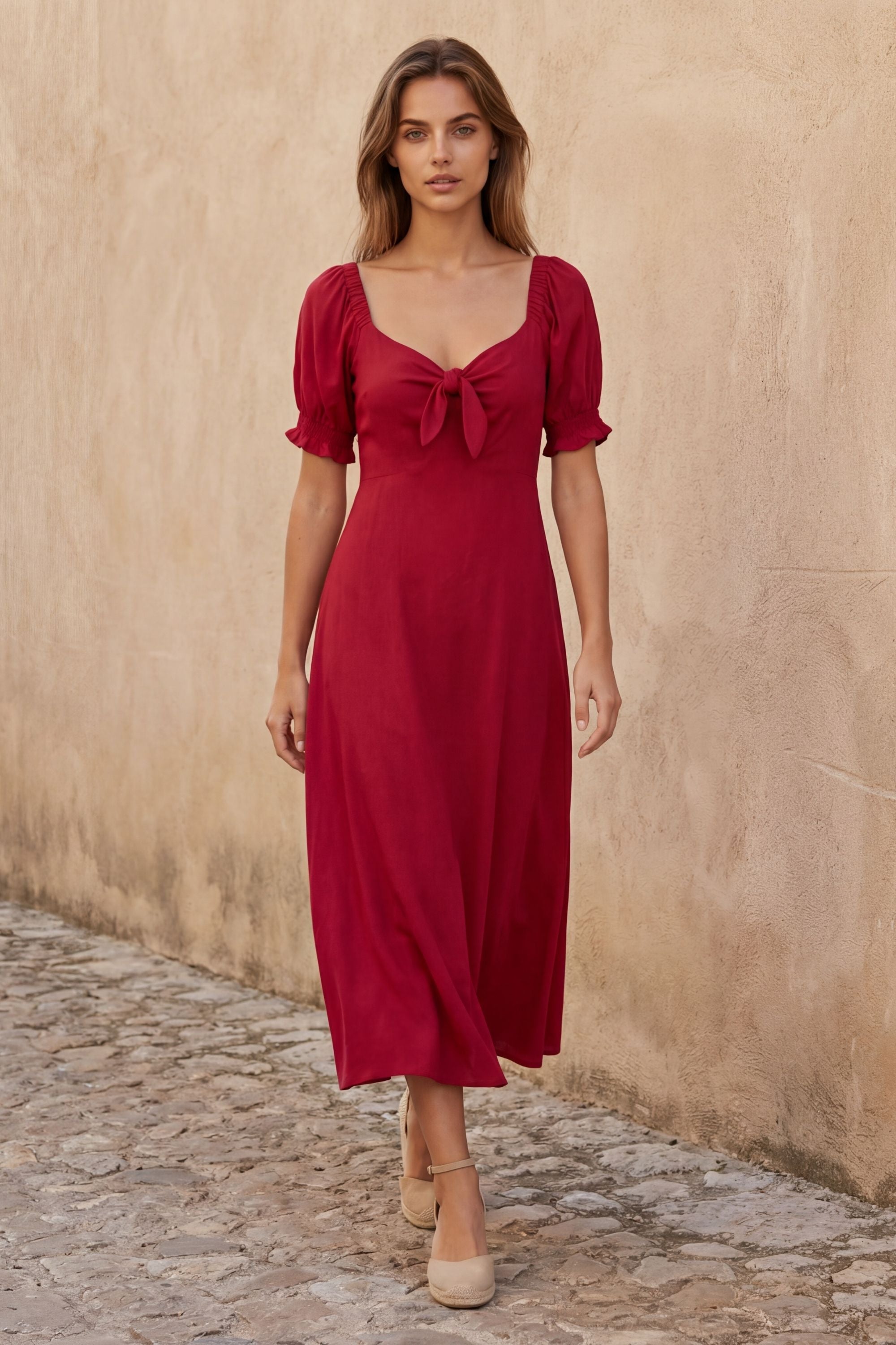 A green fit and flare midi dress with short sleeves and a front tie detail. 4