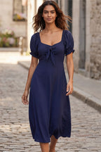 A green fit and flare midi dress with short sleeves and a front tie detail. 7