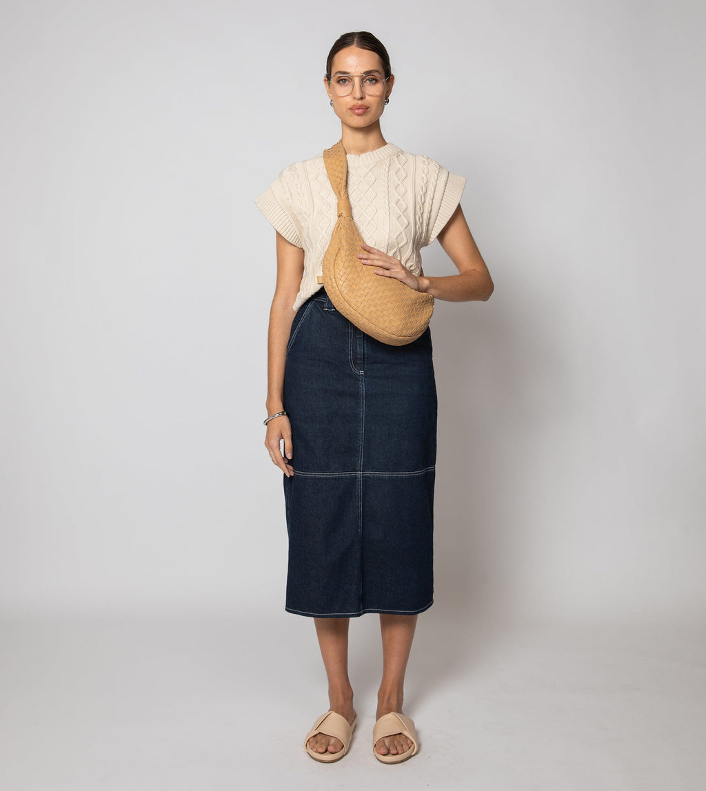 Cream cropped sweater vest in a cozy cable knit style, made from organic cotton for a soft, textured look. 3