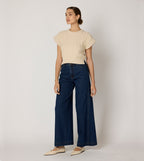 Cream cropped sweater vest in a cozy cable knit style, made from organic cotton for a soft, textured look. 4