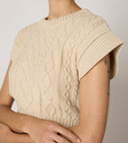 Cream cropped sweater vest in a cozy cable knit style, made from organic cotton for a soft, textured look. 5
