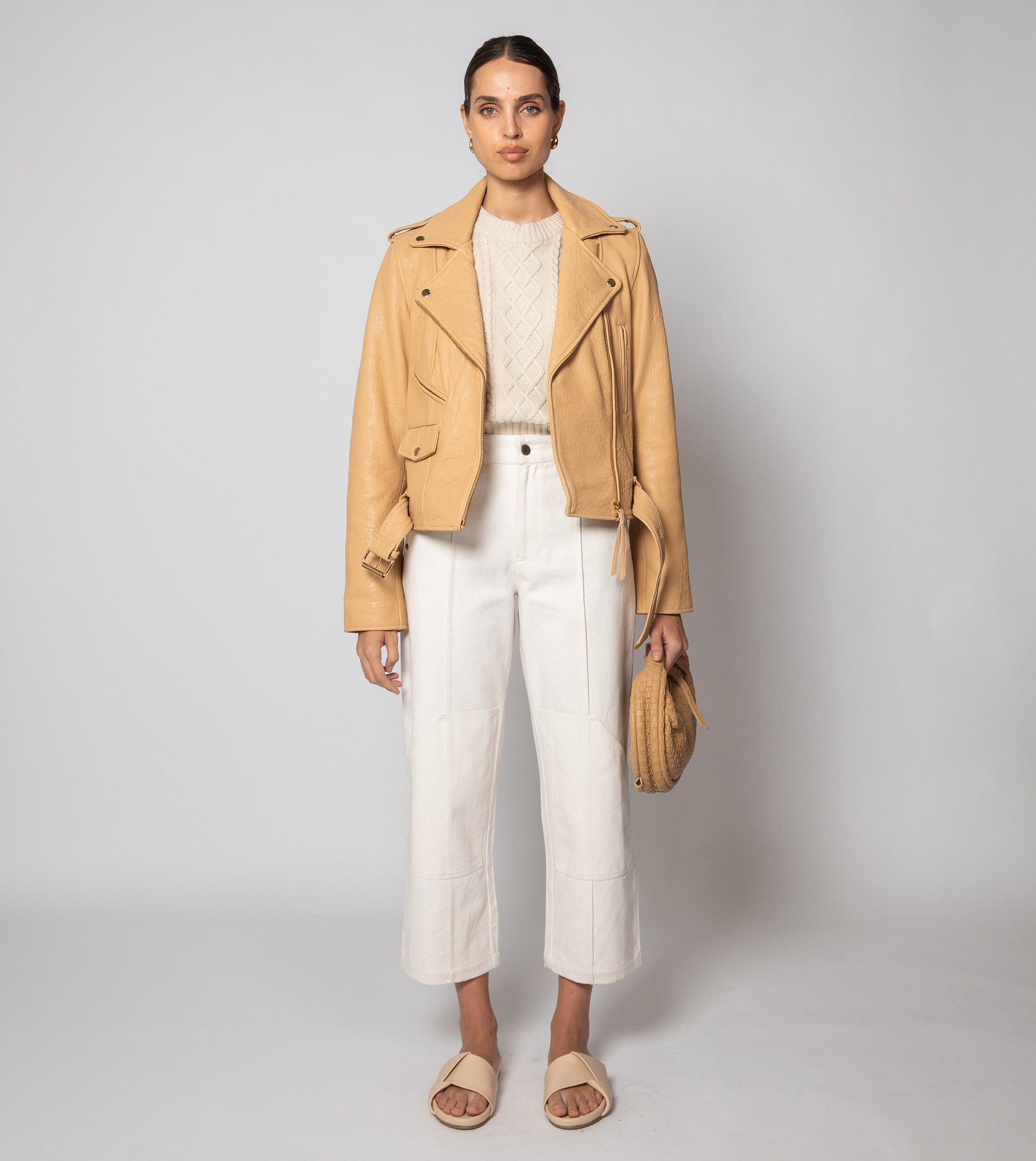 Cream cropped sweater vest in a cozy cable knit style, made from organic cotton for a soft, textured look. 7