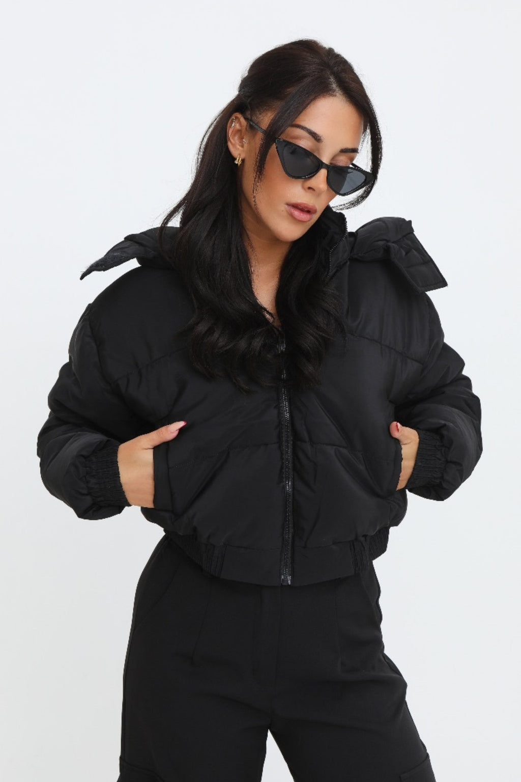 Black cropped padded jacket with long sleeves and zip front, featuring a modern and casual style. 0