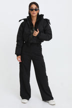 Black cropped padded jacket with long sleeves and zip front, featuring a modern and casual style. 1