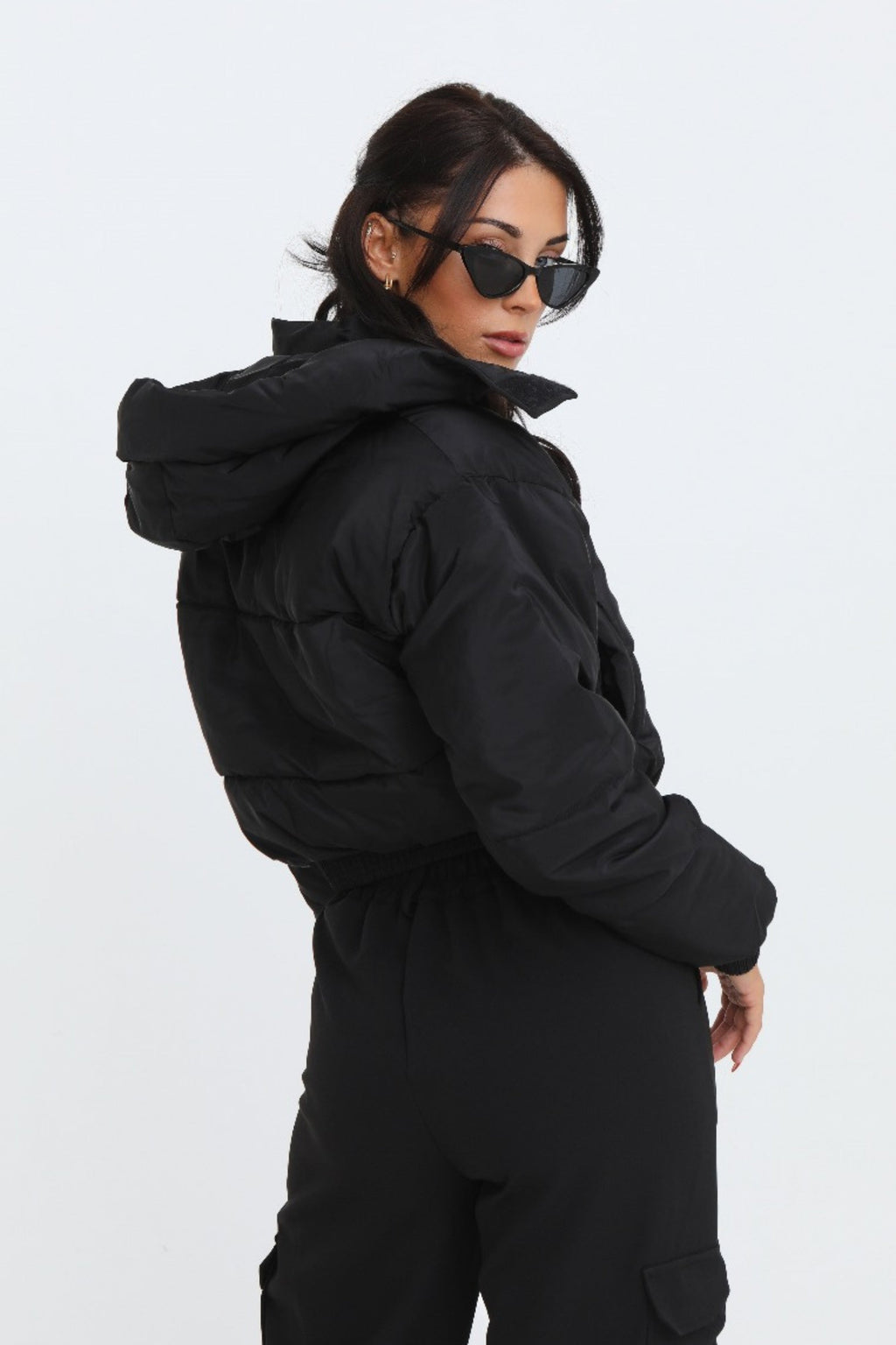 Black cropped padded jacket with long sleeves and zip front, featuring a modern and casual style. 2