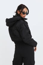 Black cropped padded jacket with long sleeves and zip front, featuring a modern and casual style. 2