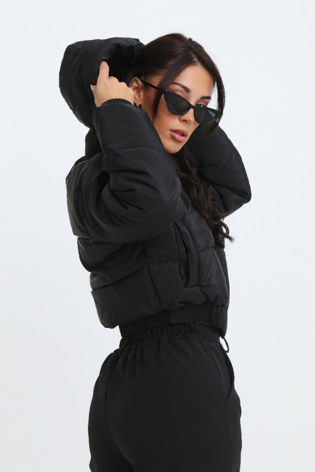 Black cropped padded jacket with long sleeves and zip front, featuring a modern and casual style. 3