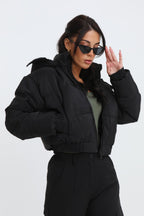 Black cropped padded jacket with long sleeves and zip front, featuring a modern and casual style. 4