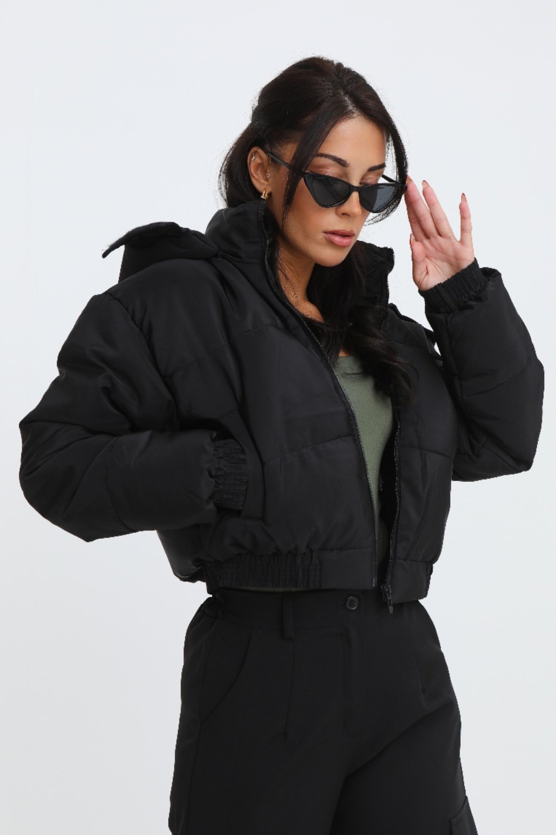 Black cropped padded jacket with long sleeves and zip front, featuring a modern and casual style. 4
