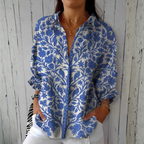 Relaxed button-down blouse in blue with a floral print. 0