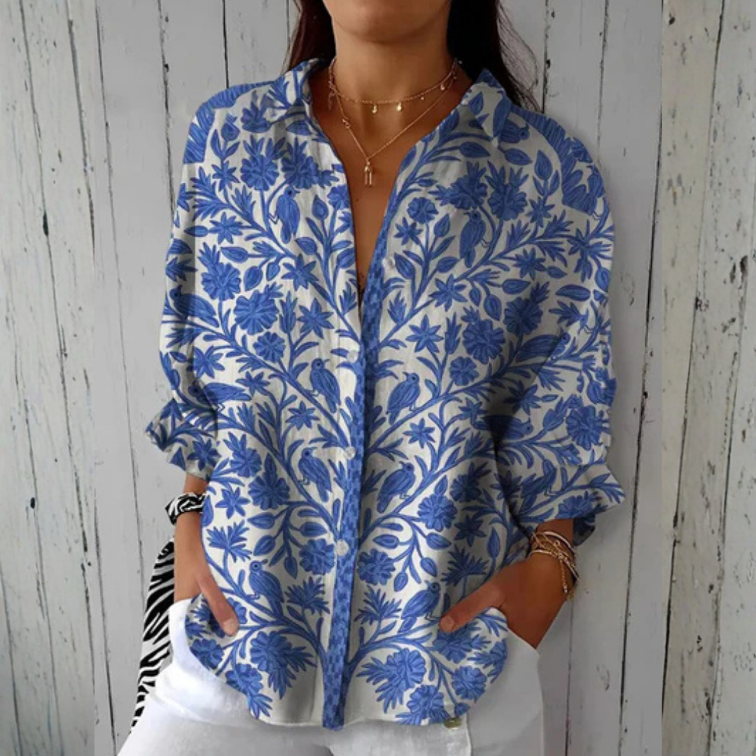 Relaxed button-down blouse in blue with a floral print. 0