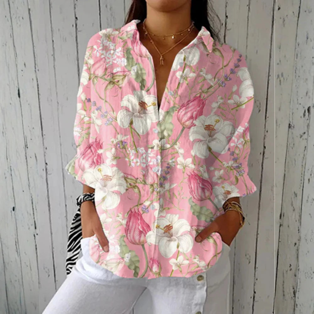 Relaxed button-down blouse in blue with a floral print. 1