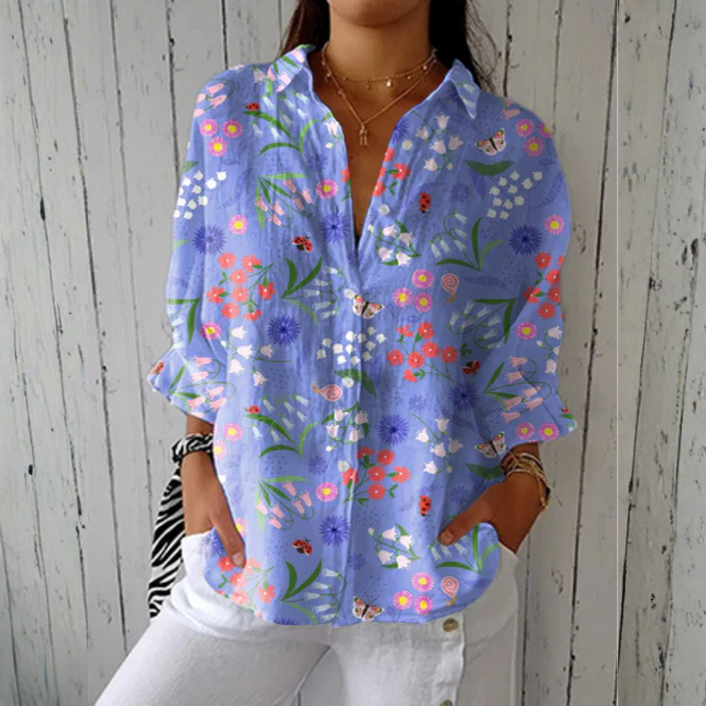 Relaxed button-down blouse in blue with a floral print. 2