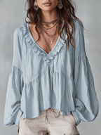 White vintage-inspired blouse with ruffles, perfect for summer. Lightweight and airy design. 5
