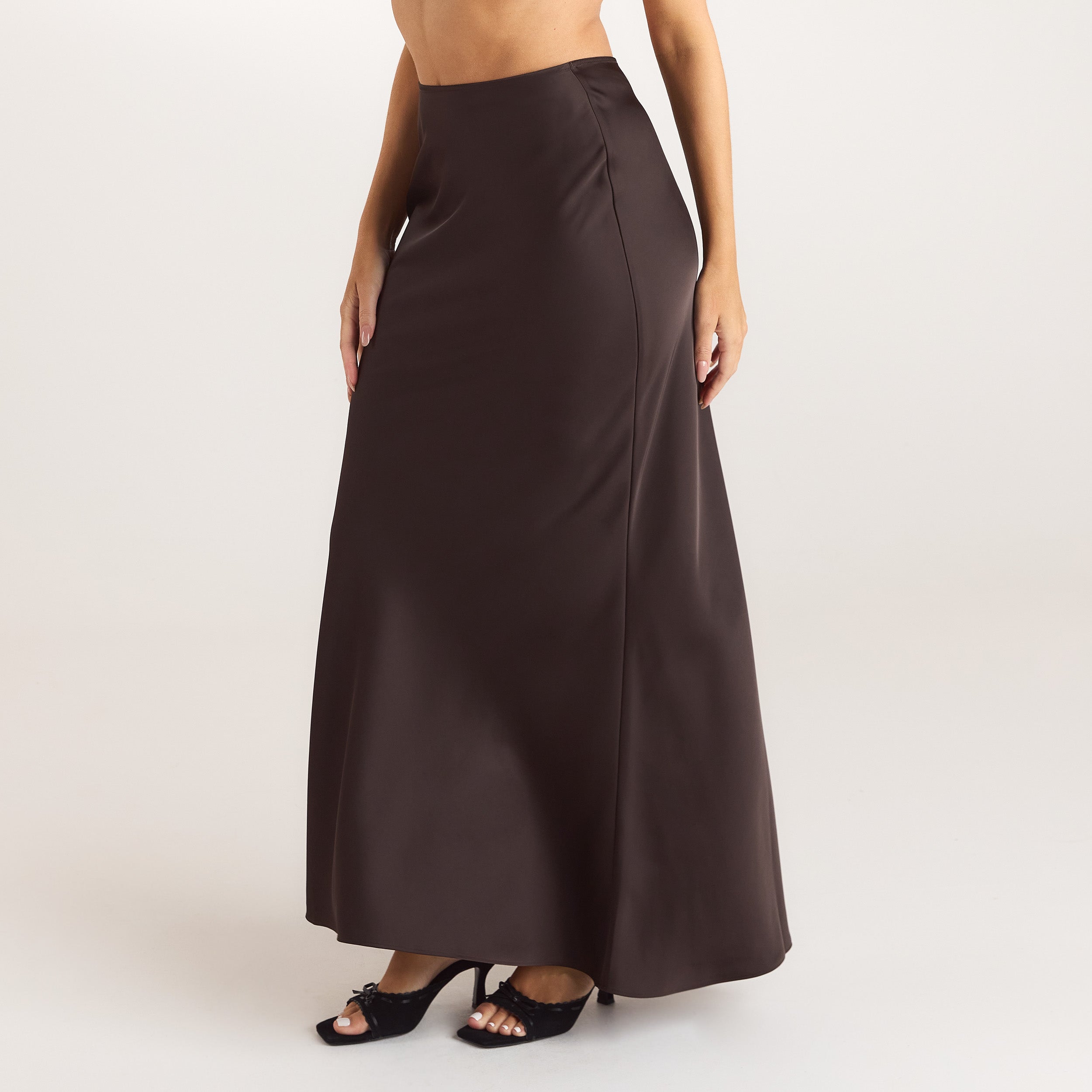 Chocolate satin fitted maxi skirt with an elasticated waistband, offering a sleek and elegant silhouette. 4