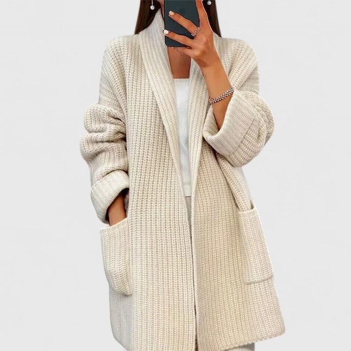 Cream longline ribbed cardigan for women with a shawl collar and deep patch pockets.