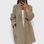 Longline ribbed cardigan for women with a shawl collar and deep patch pockets.