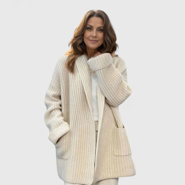 Longline ribbed cardigan for women with a shawl collar and deep patch pockets.