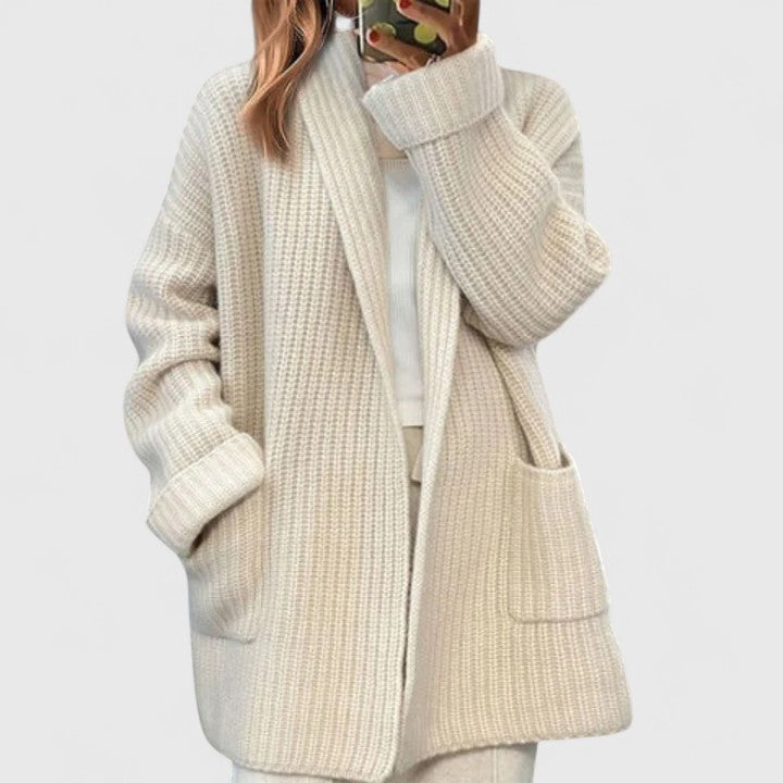 Longline ribbed cardigan for women with a shawl collar and deep patch pockets.