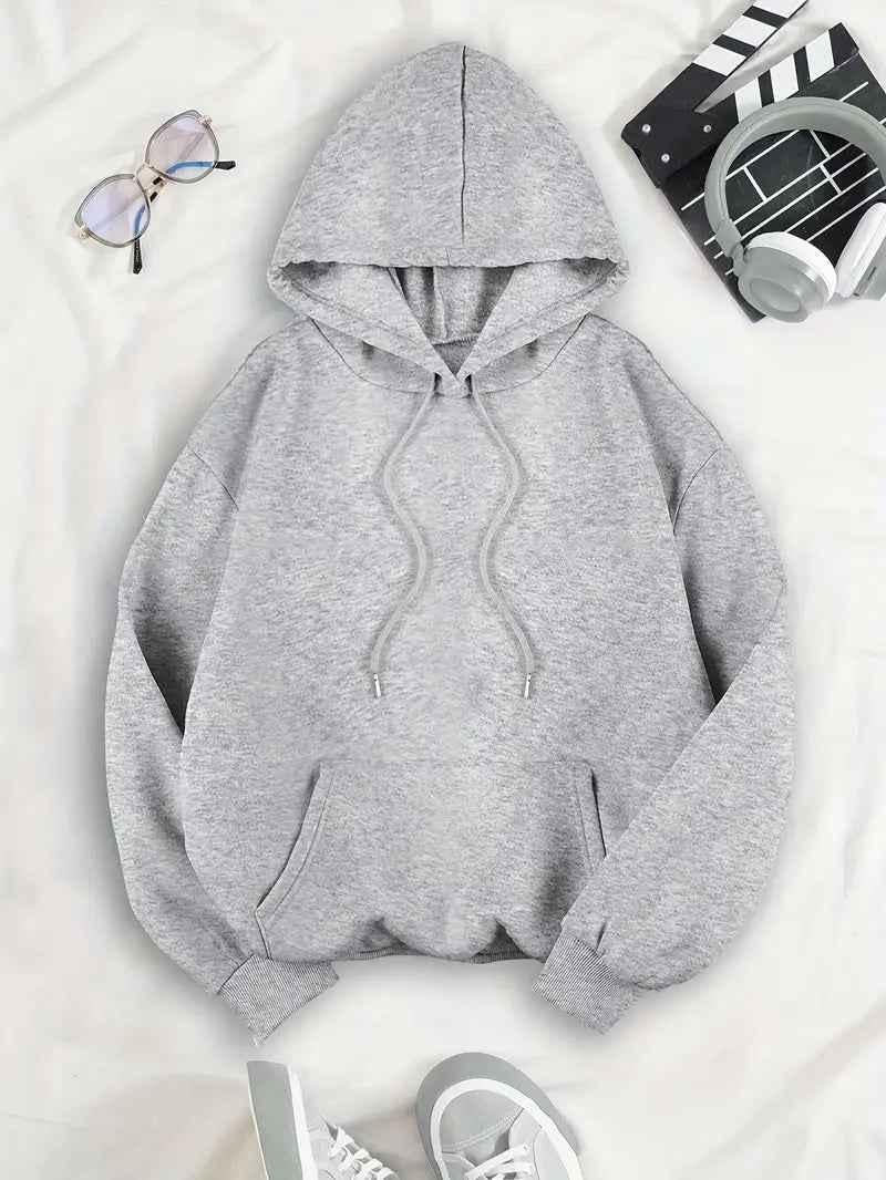Front of the light grey oversized women's hoodie with drawstring hood and kangaroo pocket.