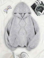 Front of the light grey oversized women's hoodie with drawstring hood and kangaroo pocket.