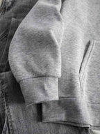 Close-up of the ribbed cuff and hem on the oversized women's hoodie.