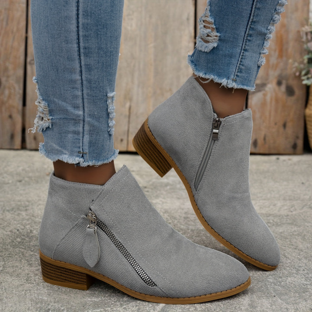 Women's block heel shoes in navy blue, featuring a zip closure and a modern, comfortable design. 11