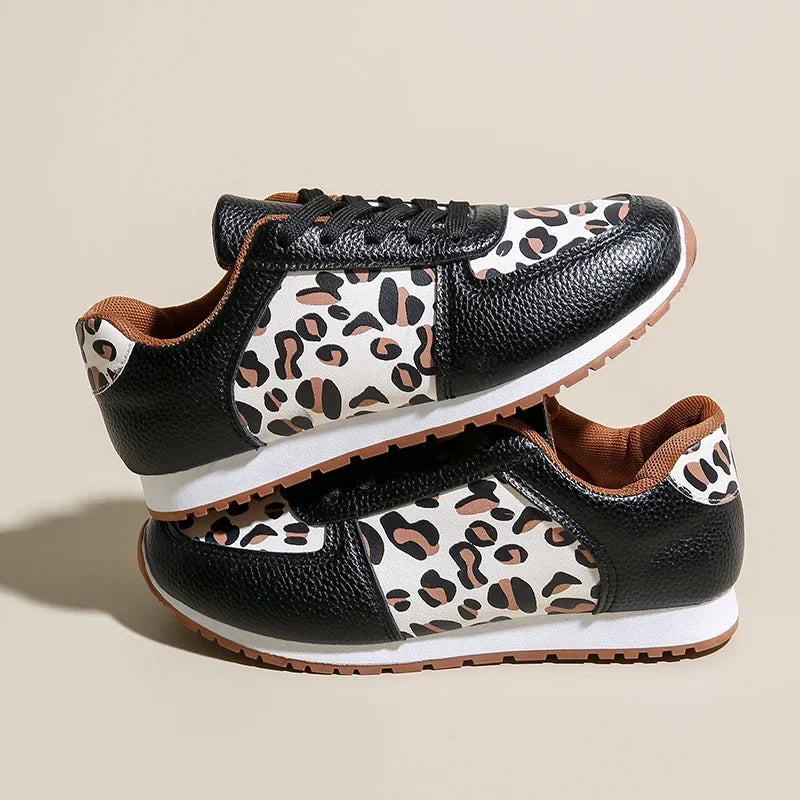 Leopard print running shoes in brown and black, featuring a sporty design and lightweight construction. 1