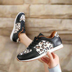 Leopard print running shoes in brown and black, featuring a sporty design and lightweight construction. 5