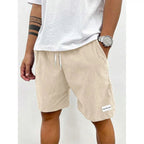 Men's relaxed-fit ribbed shorts in a soft grey color with an adjustable waistband. 0