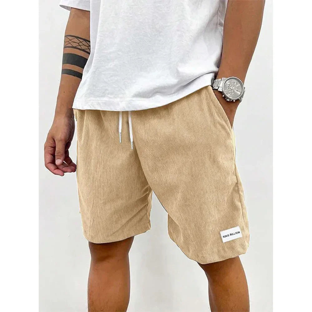 Men's relaxed-fit ribbed shorts in a soft grey color with an adjustable waistband. 1