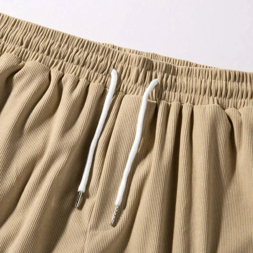 Men's relaxed-fit ribbed shorts in a soft grey color with an adjustable waistband. 4