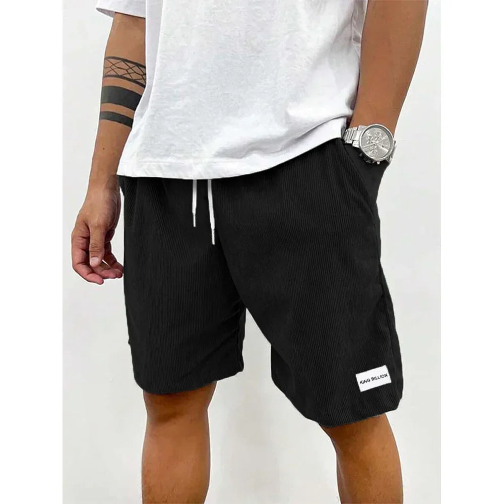 Men's relaxed-fit ribbed shorts in a soft grey color with an adjustable waistband. 7