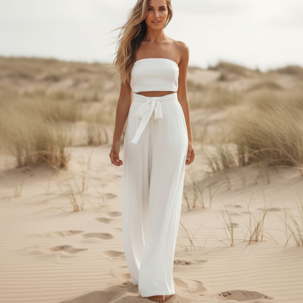 Backless bohemian jumpsuit in lilac with a bow tie waist, featuring a relaxed fit and flowing silhouette. 0