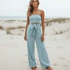 Backless bohemian jumpsuit in lilac with a bow tie waist, featuring a relaxed fit and flowing silhouette. 2