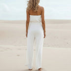 Backless bohemian jumpsuit in lilac with a bow tie waist, featuring a relaxed fit and flowing silhouette. 4