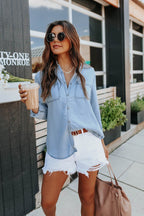 Light blue chambray button-down shirt with roll-tab sleeves and pockets, featuring a casual and relaxed style. 6