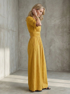 Lila wide leg jumpsuit in deep violet with a cross front and elbow-length sleeves, featuring a chic and elegant style. 1