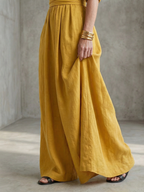 Lila wide leg jumpsuit in deep violet with a cross front and elbow-length sleeves, featuring a chic and elegant style. 2
