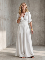Lila wide leg jumpsuit in deep violet with a cross front and elbow-length sleeves, featuring a chic and elegant style. 3