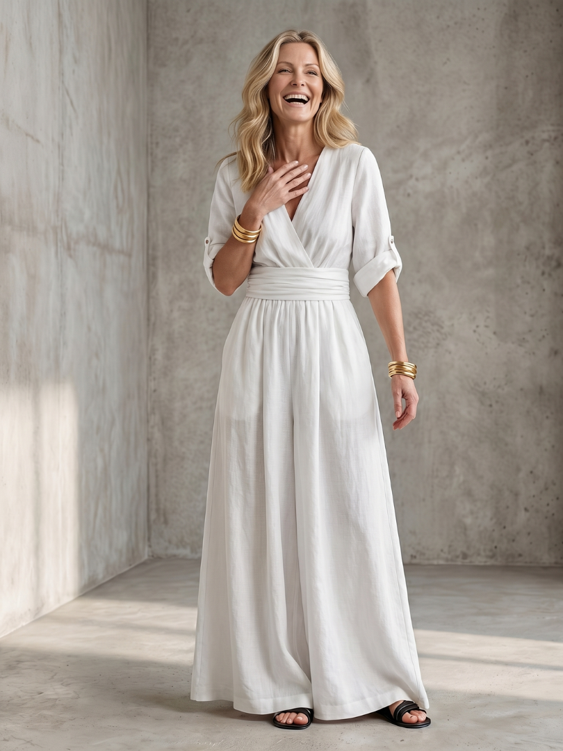 Lila wide leg jumpsuit in deep violet with a cross front and elbow-length sleeves, featuring a chic and elegant style. 3