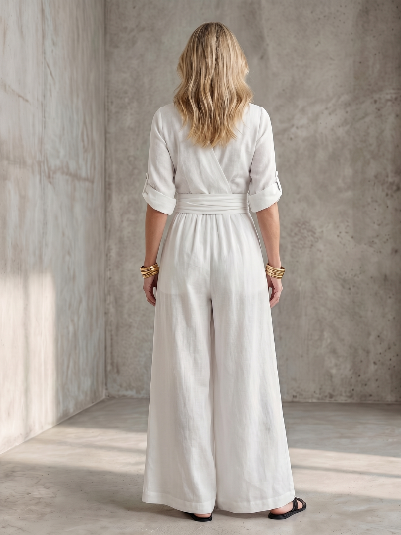 Lila wide leg jumpsuit in deep violet with a cross front and elbow-length sleeves, featuring a chic and elegant style. 5