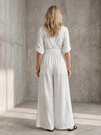 Lila wide leg jumpsuit in deep violet with a cross front and elbow-length sleeves, featuring a chic and elegant style. 5