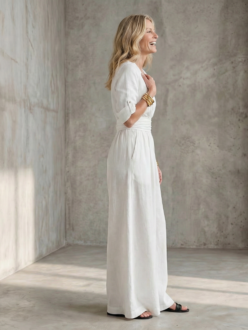 Lila wide leg jumpsuit in deep violet with a cross front and elbow-length sleeves, featuring a chic and elegant style. 6