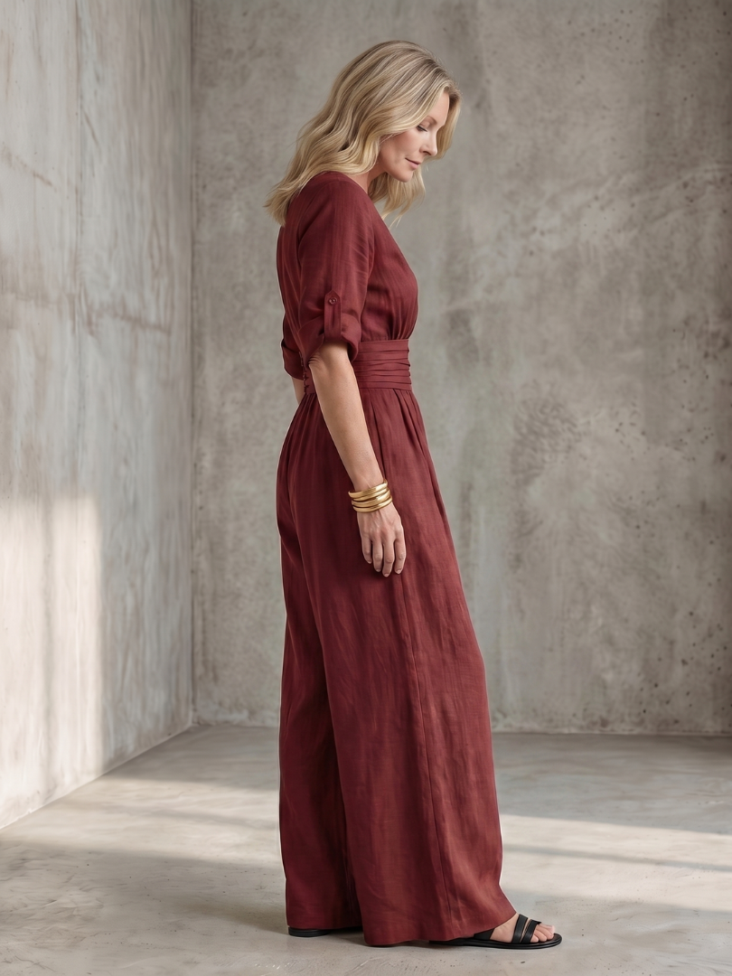 Lila wide leg jumpsuit in deep violet with a cross front and elbow-length sleeves, featuring a chic and elegant style. 8