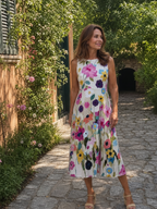 Lila floral midi dress, lightweight fabric, sleeveless, featuring a vibrant floral pattern in soft pastel colors. 5