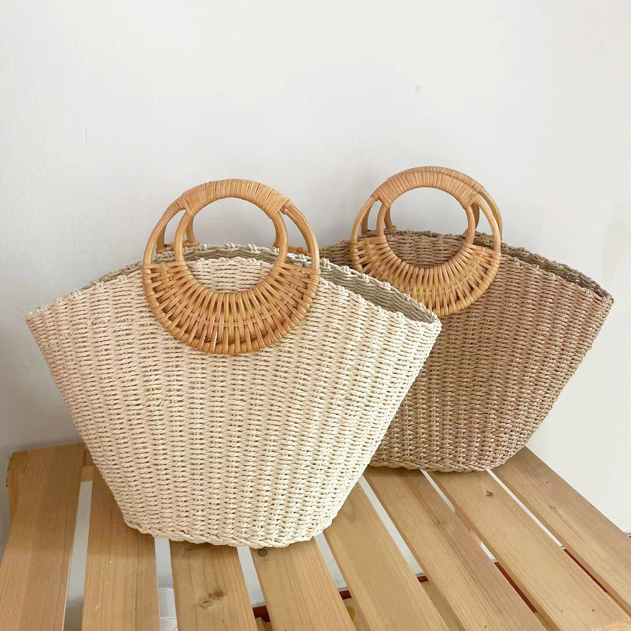 Lila woven straw tote bag in natural tones with wooden handles, perfect for carrying beach essentials. 4