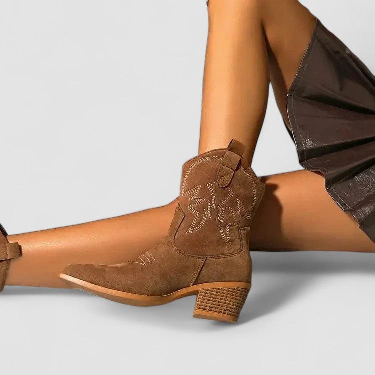 Women's orthopedic suede-look western ankle boots with contrast stitching and a stacked heel.