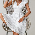 Lightweight summer dress in soft pink with flutter sleeves, perfect for casual outings. 3